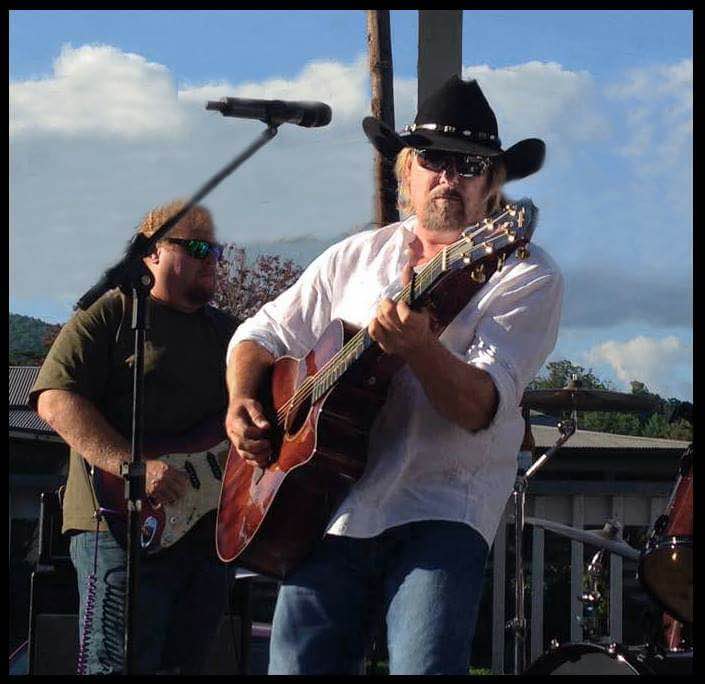 Musicians performing outdoors on stage