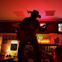 Cowboy playing guitar onstage