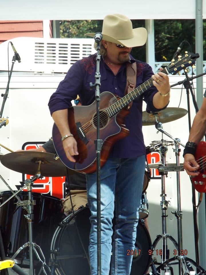 Musician playing guitar on stage