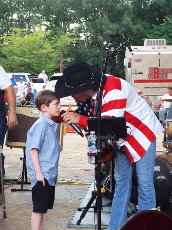 Musician interacting with young boy