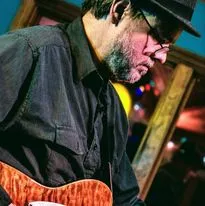 Musician playing guitar focused