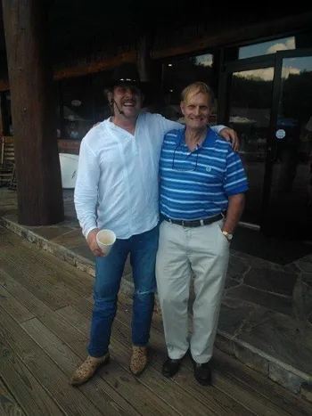 Two men posing together outdoors