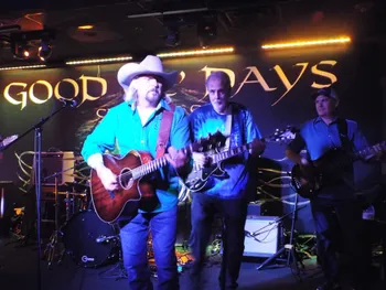 Musicians performing under mural