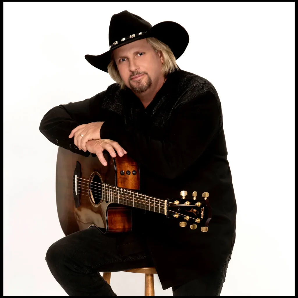 Man with guitar and cowboy hat